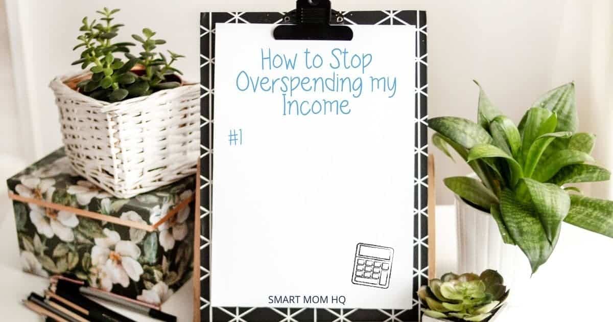 clipboard sitting up on table by plants with writing how to stop overspending your income