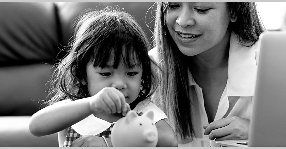 money category page mom helping daughter put change in a piggy bank