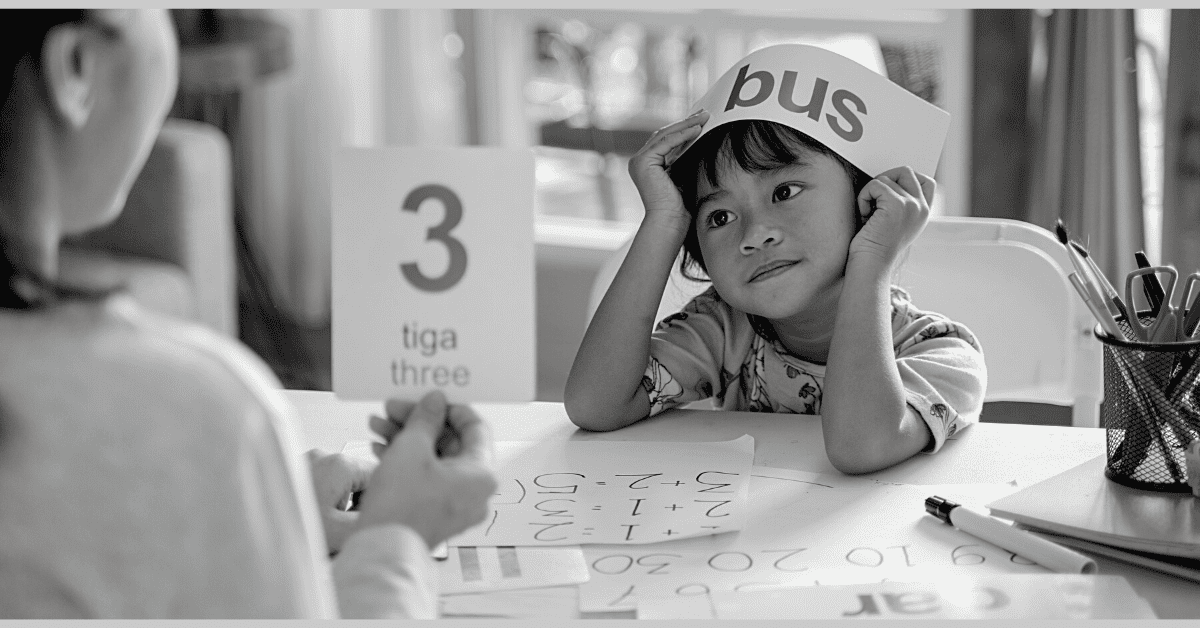 mom teaching small boy numbers with flash cards