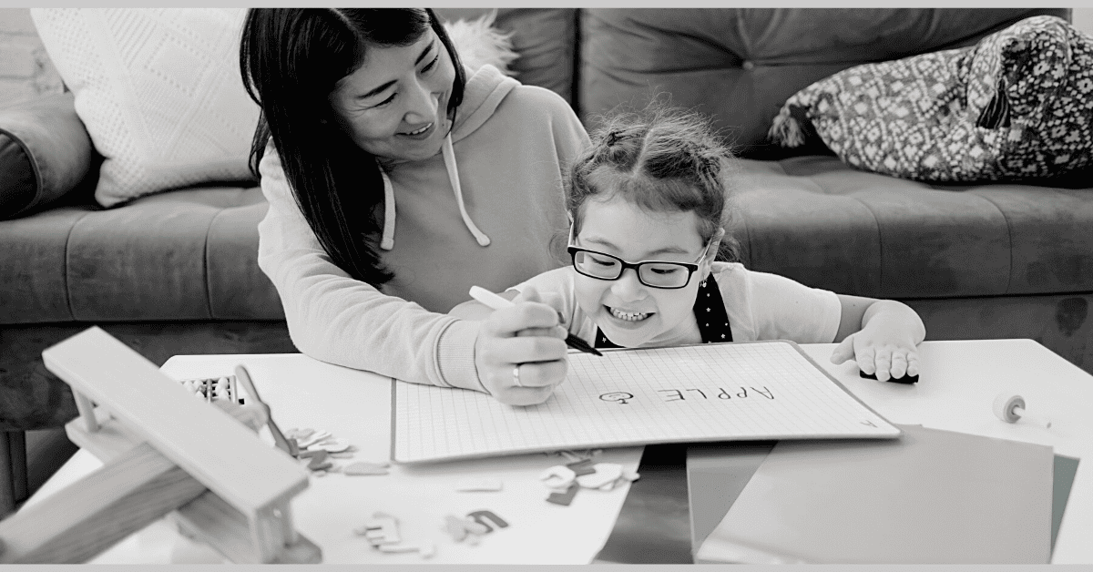 writing and grammar momm and child with glasses practicing learning to write